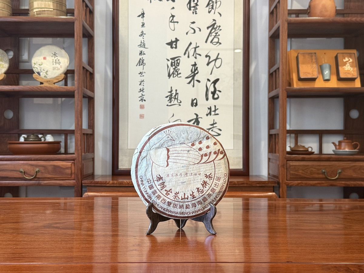 2003 Bulang Mountain Raw Pu-erh Tea Cake Displayed in a Traditional Tea House