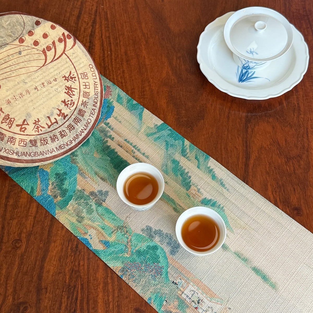 2003 Bulang Mountain raw Pu-erh tea cake and brewed tea liquor