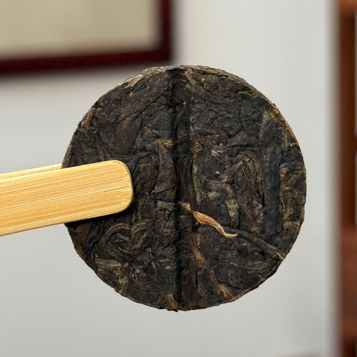 Close-up of Raw Pu-erh Mini Tea Cake 2018 Aged sample, showing texture