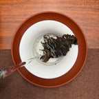 Brewing 2015 Fuding Gong Mei White Tea Cake (Tribute Eyebrow), an aged Chinese white tea
