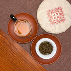 2016 He Kai Raw Pu-erh Tea Cake with brewed tea liquor and opened leaves showing aged Pu-erh tea quality