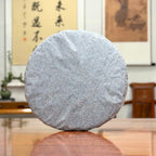 2016 He Kai Raw Pu-erh Tea Cake with traditional inner cotton paper wrapping for authentic aged Pu-erh tea storage