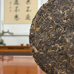 2016 He Kai Raw Pu-erh Tea Cake showing detailed tea leaves and traditional pressed texture of aged Pu-erh tea