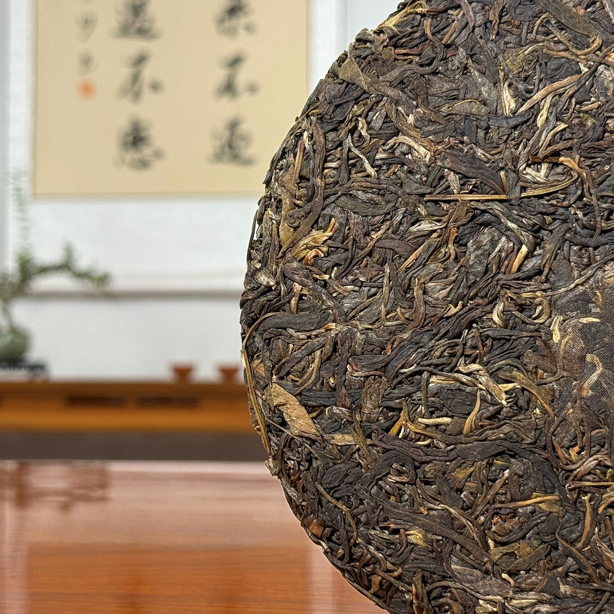 2016 He Kai Raw Pu-erh Tea Cake showing detailed tea leaves and traditional pressed texture of aged Pu-erh tea