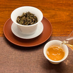 2016 He Kai Raw Pu-erh Tea Cake tea liquor displayed after brewing with smooth aged Pu-erh tea color