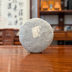 2017 Golden Charm Raw Pu'er Tea Cake Displayed in Traditional Tea House
