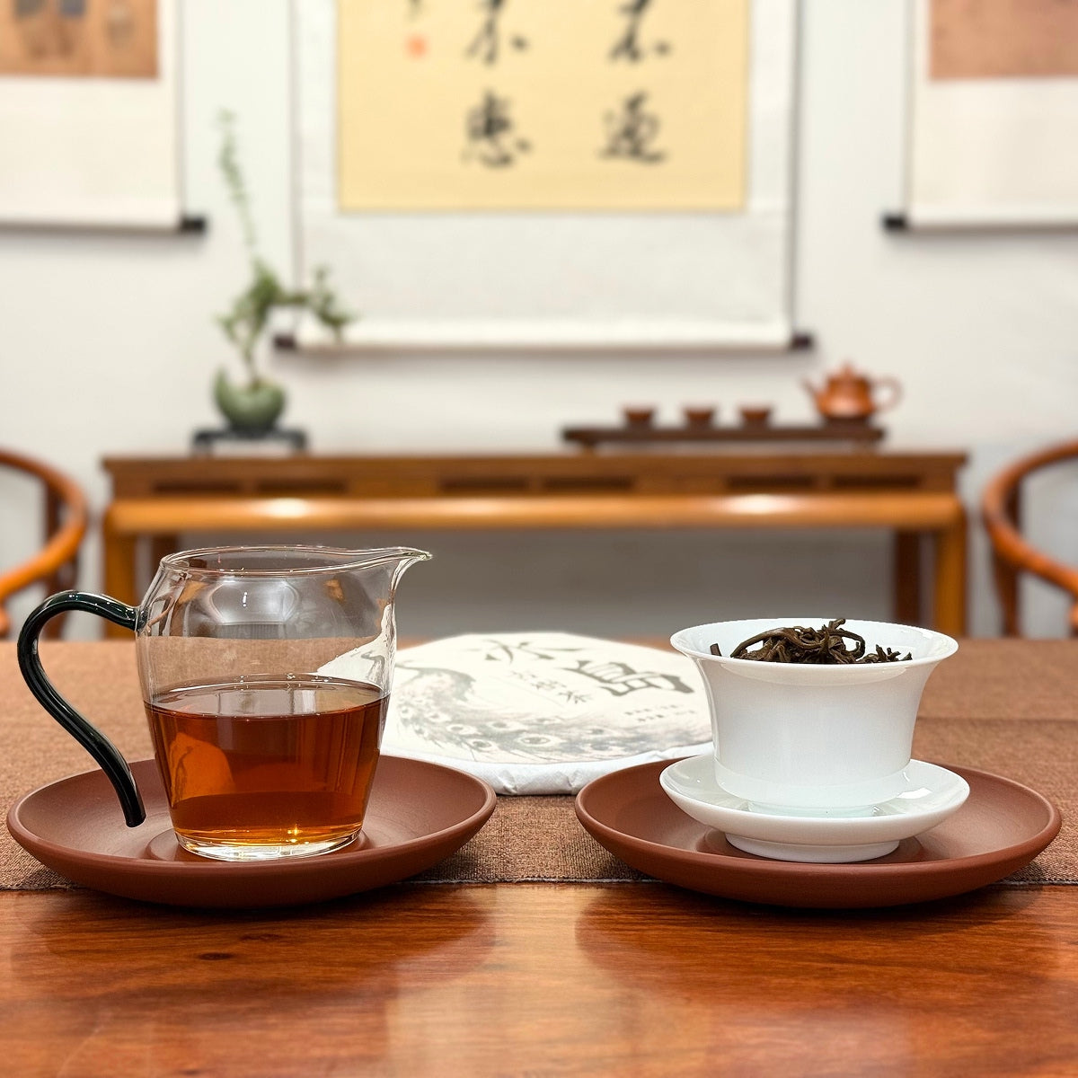 2018 Bing Dao Ancient Tree Raw Pu'er Tea Cake displayed with tea liquor, highlighting the character of Yunnan Pu'er tea