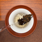 2019 Lao Ban Zhang Golden Tips Ripe Pu-erh Tea Cake being brewed in a traditional tea setting