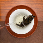 Brewing the 2019 Xi Niu Tang Ancient Tree Raw Pu-erh Tea Cake from Pasha tea region in a Chinese tea house