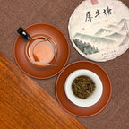 Infused leaves and tea liquor of the 2019 Xi Niu Tang Ancient Tree Raw Pu-erh Tea Cake