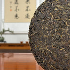 2019 Yunnan Qizi Bing Raw Pu-erh Tea Cake (Sheng) close-up showing compressed tea leaves and texture