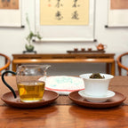2019 Yunnan Qizi Bing Raw Pu-erh Tea Cake (Sheng) with the tea cake and brewed liquor