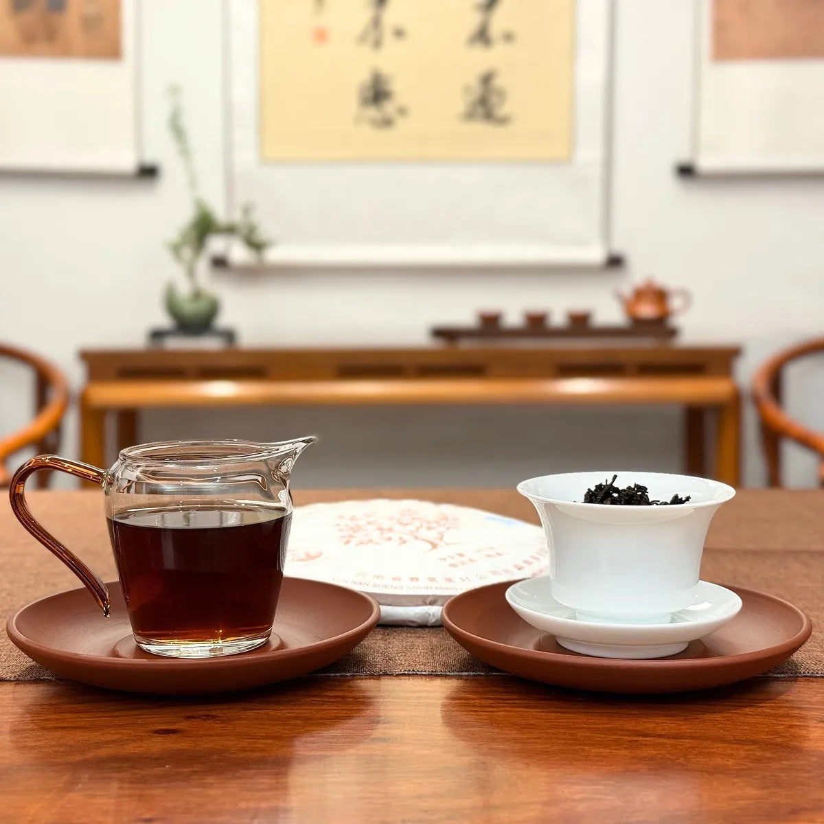 2019 Yunnan Qizi Bing Ripe Pu-erh Tea Cake with brewed tea and traditional tea cake presentation