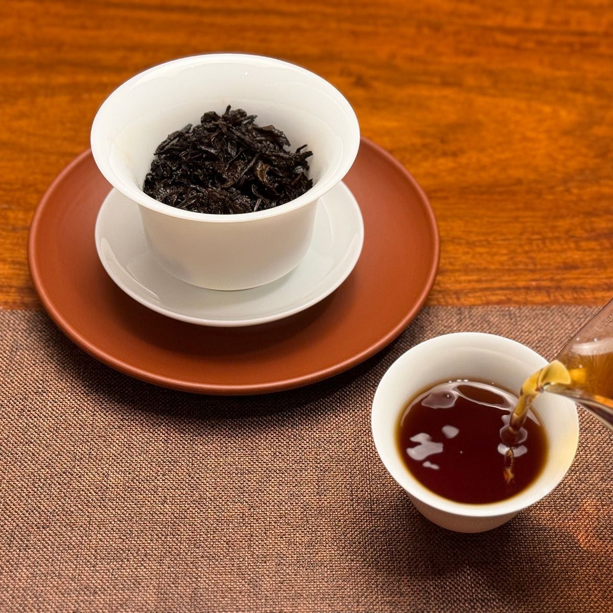 2020 Arbor Tree Ripe Pu-erh Tea Cake (Shou) with clear deep red tea liquor after brewing