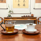 2020 Yiwu Mahei Raw Pu-erh Tea Cake with brewed tea liquor and full tea cake