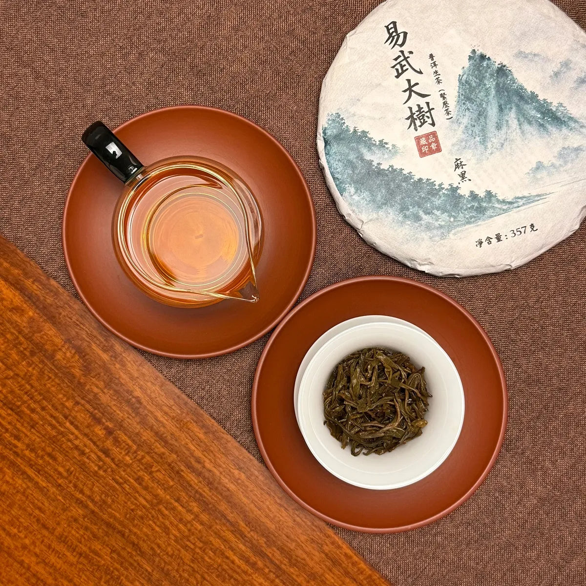 2020 Yiwu Mahei Raw Pu-erh Tea Cake with brewed tea liquor and tender infused leaves