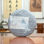 2020 Yiwu Mahei Raw Pu-erh Tea Cake with its original inner wrapper revealed