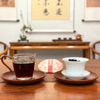 2021 Imperial-Grade Ripe Pu-erh Tea Cake (Shou) with tea leaves, tea cake, and brewed liquor