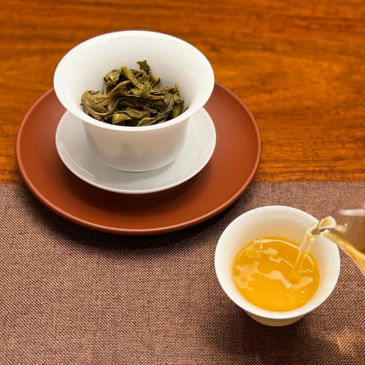 2022 Ban Pen Ancient Tree Raw Pu-erh Tea Cake with clear tea liquor displayed at Chinese Tea Group tea house