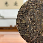 2023 Da Xue Shan Ancient Tree Raw Pu-erh Tea Cake close-up showing detailed tea leaves and texture