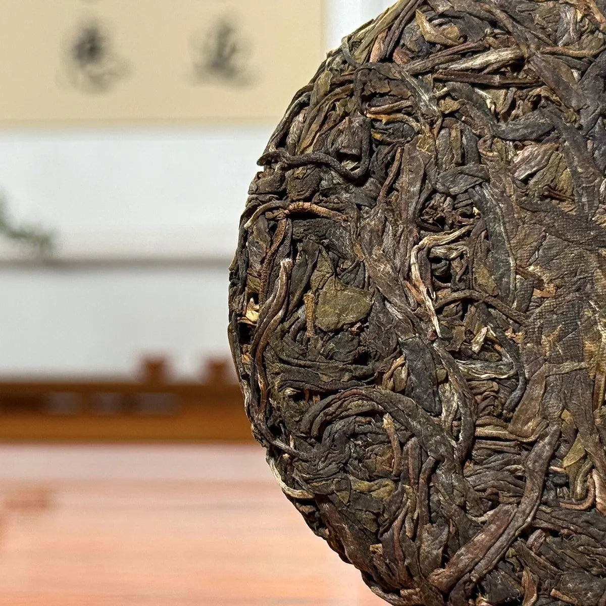 2023 Da Xue Shan Ancient Tree Raw Pu-erh Tea Cake close-up showing detailed tea leaves and texture