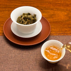 2024 Lin Cang Ancient Tree Raw Pu-erh Tea Cake showing its golden tea liquor after brewing.