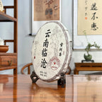 2024 Lin Cang Ancient Tree Raw Pu-erh Tea Cake side view showing the traditional compressed cake shape.