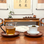 2024 Lin Cang Ancient Tree Raw Pu-erh Tea Cake displayed with brewed tea liquor.