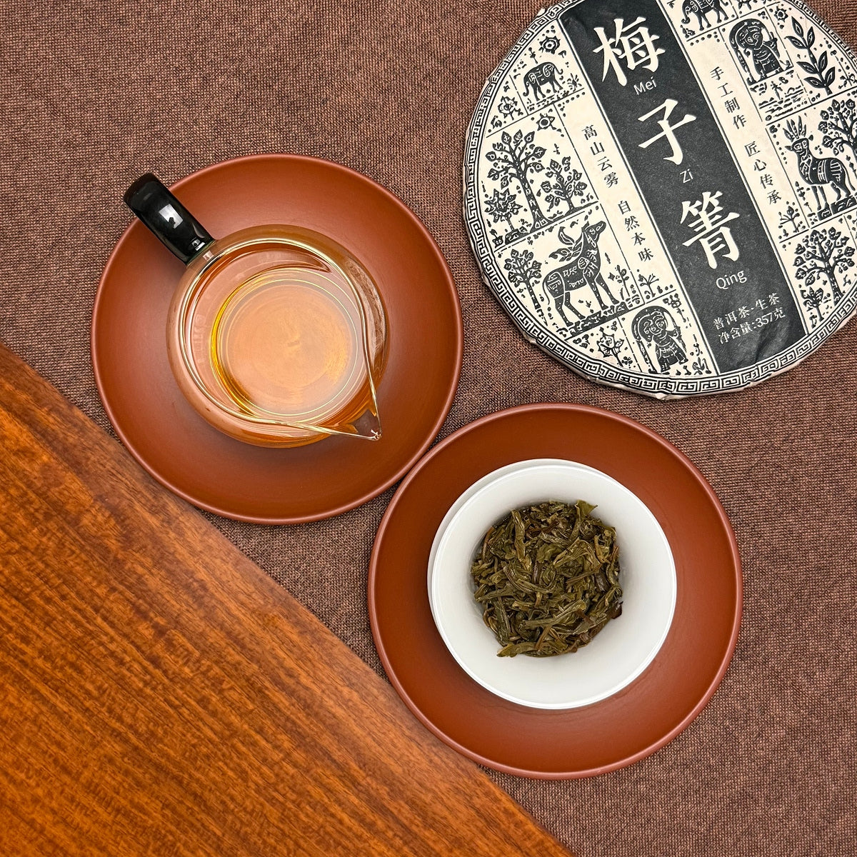 2024 Mei Zi Qing Raw Pu-erh Tea Cake with brewed tea leaves and clear liquor