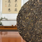 2024 Mei Zi Qing Raw Pu-erh Tea Cake showing detailed leaf texture and tea strands