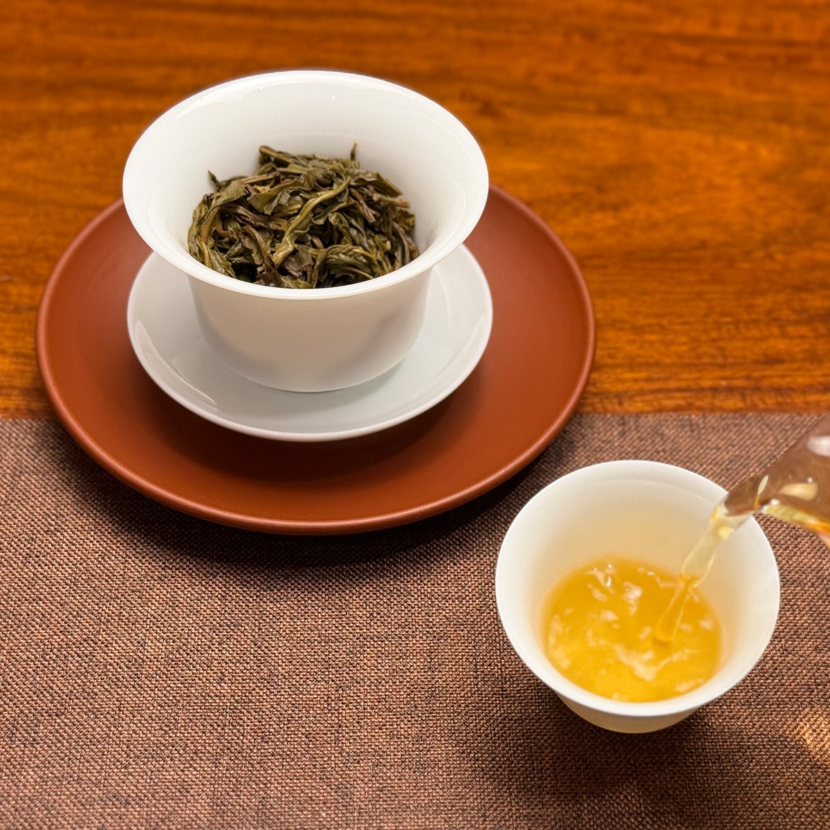 2024 Mei Zi Qing Raw Pu-erh Tea Cake showing bright golden tea liquor after brewing