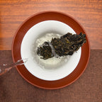 2024 Mei Zi Qing Raw Pu-erh Tea Cake being brewed in a traditional Chinese tea room