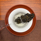 2024 Mei Zi Qing Raw Pu-erh Tea Cake being brewed in a traditional Chinese tea room