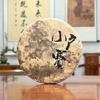 2024 Xiao Hu Sai Raw Pu-erh Tea Cake displayed in a Chinese tea store with authentic Yunnan tea heritage