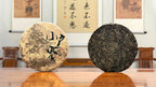 2024 Xiao Hu Sai Raw Pu-erh Tea Cake presented in a traditional Chinese tea room atmosphere