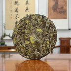 Close-up of 2025 Bai Mu Dan White Tea Cake highlighting the delicate texture of the tea leaves.