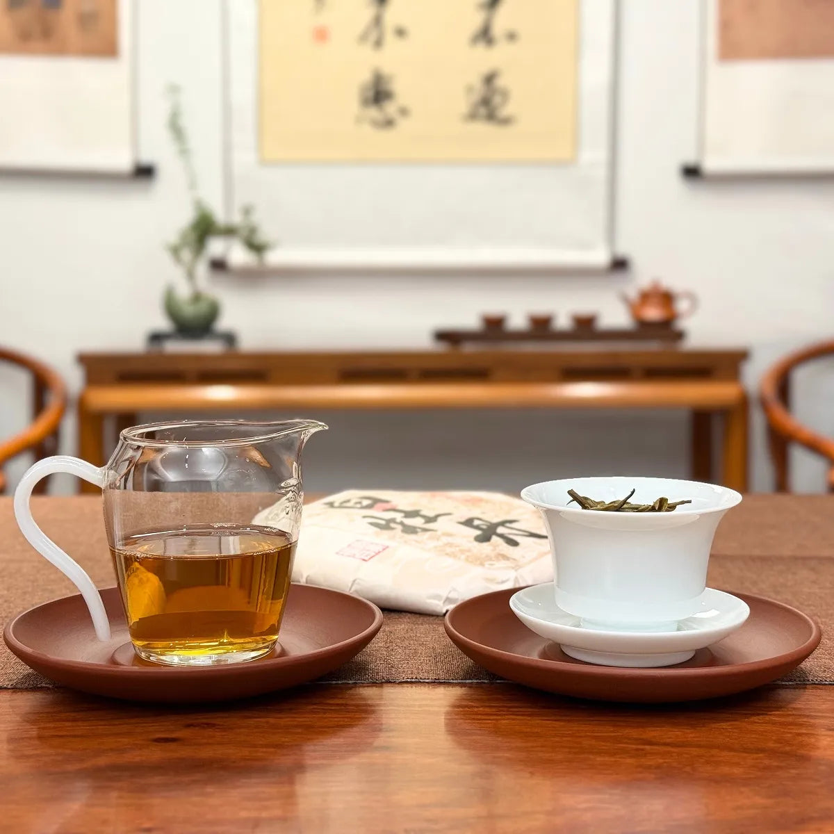 2025 Bai Mu Dan White Tea Cake presented alongside its brewed tea liquor.