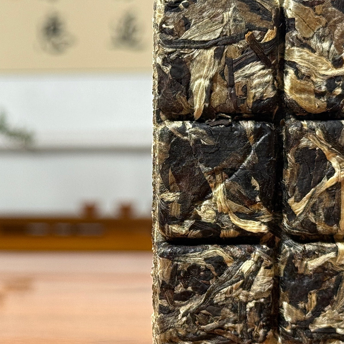 2025 Yunnan White Tea Mini Bricks showing compressed dry tea leaves with natural texture