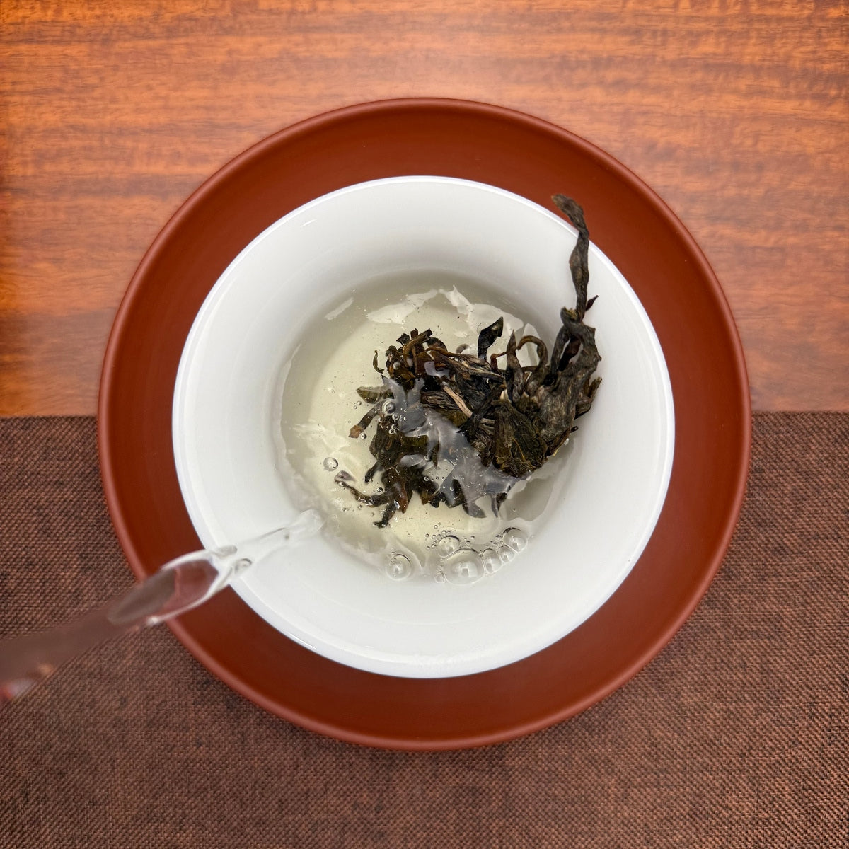 2026 Bulang Mountain Raw Pu-erh Tea Cake being brewed in a traditional tea setting
