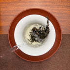 2026 Bulang Mountain Raw Pu-erh Tea Cake being brewed in a traditional tea setting