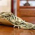 Bai Hao Yin Zhen White Tea (Silver Needle) dry leaves close-up in Chinese Tea Group authentic tea store