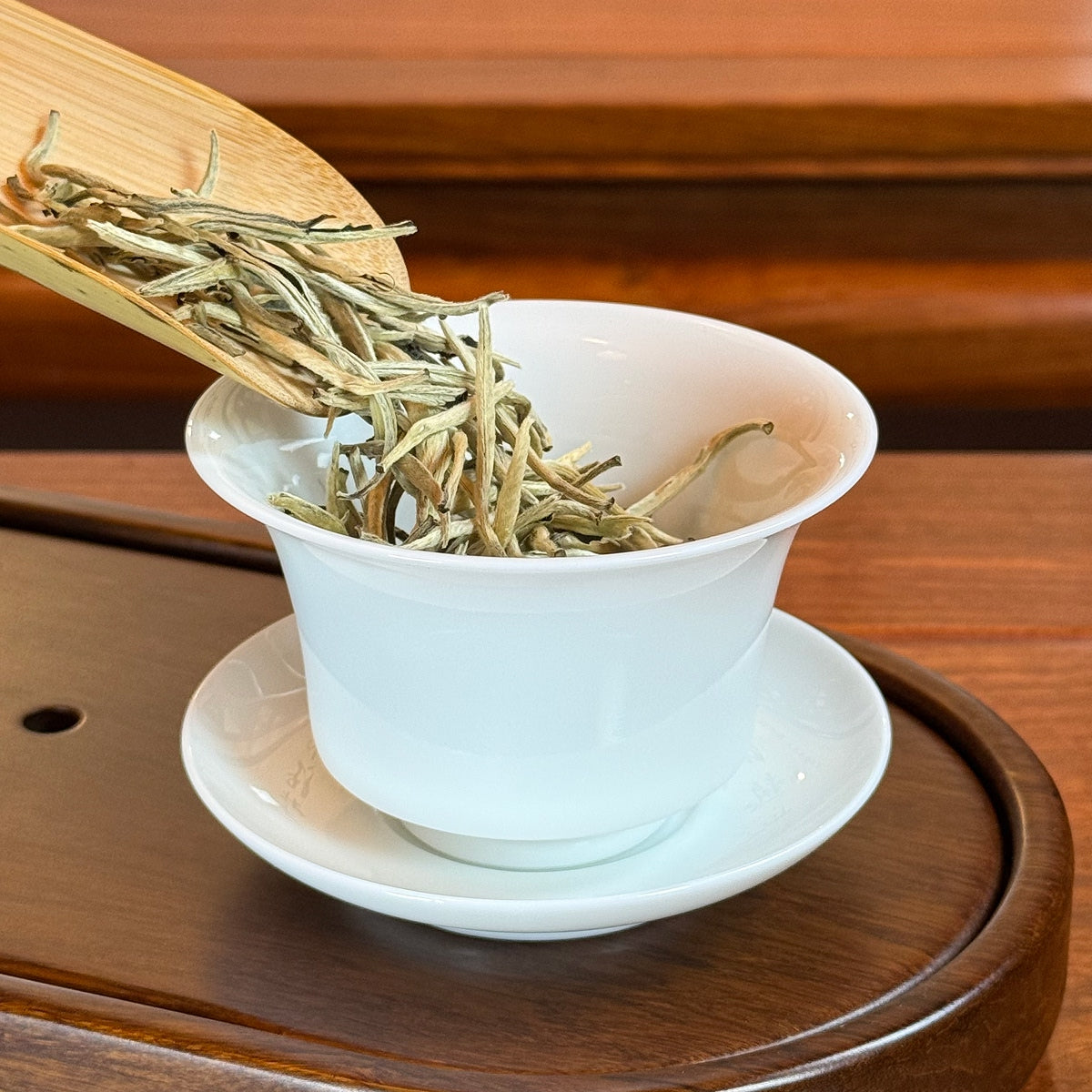 Bai Hao Yin Zhen White Tea (Silver Needle) dry leaves poured into teaware for brewing