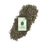 Dry tea leaves with packaging of Chinese Green Tea Gongfu Sachets, showing premium AAA Grade quality