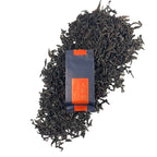 Dry tea leaves with packaging of Oolong Gongfu Tea Sachets Da Hong Pao, showing premium quality