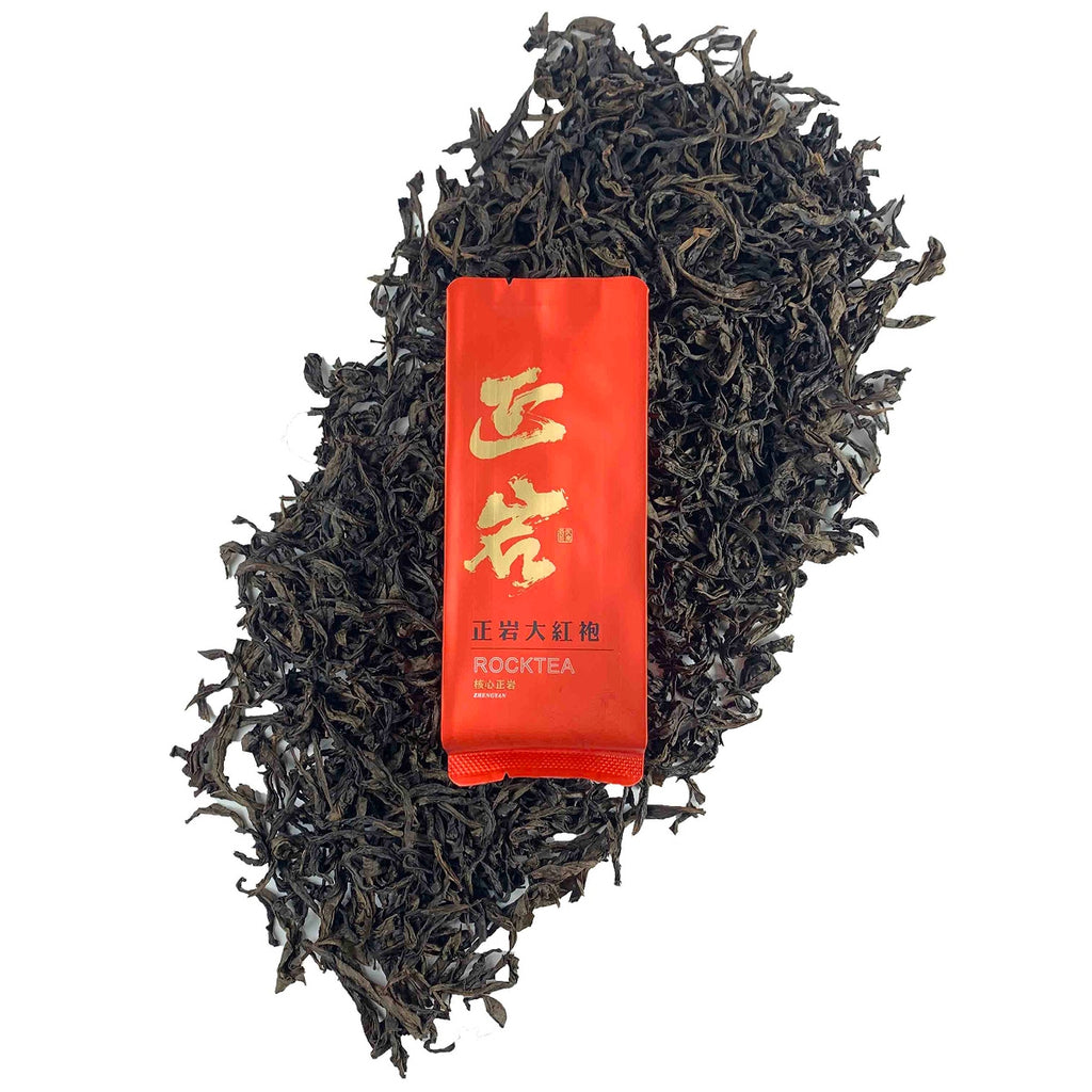 Dry tea leaves with packaging of Da Hong Pao Oolong Gongfu Tea Sachets, showing premium quality