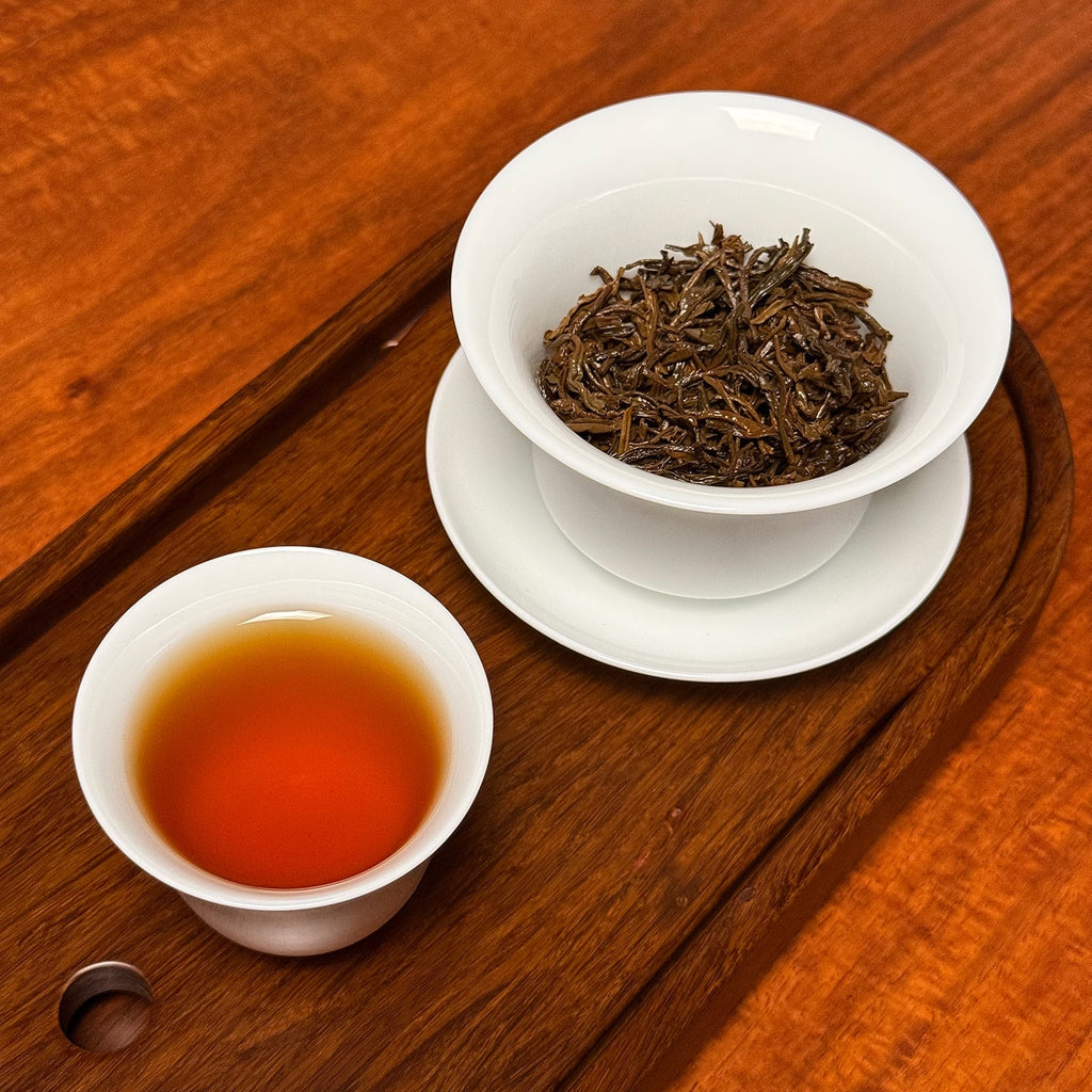 Jin Jun Mei Black Tea (Golden Eyebrow) brewed tea liquor showing amber color and smooth clarity