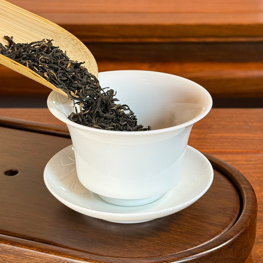 Jin Jun Mei Black Tea (Golden Eyebrow) leaves being poured into Chinese tea ware
