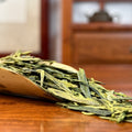 Long Jing Green Tea (Dragon Well) dry leaves close-up shot in Chinese Tea Group tea house