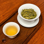Long Jing Green Tea (Dragon Well) brewed tea liquor showing bright green color and clarity