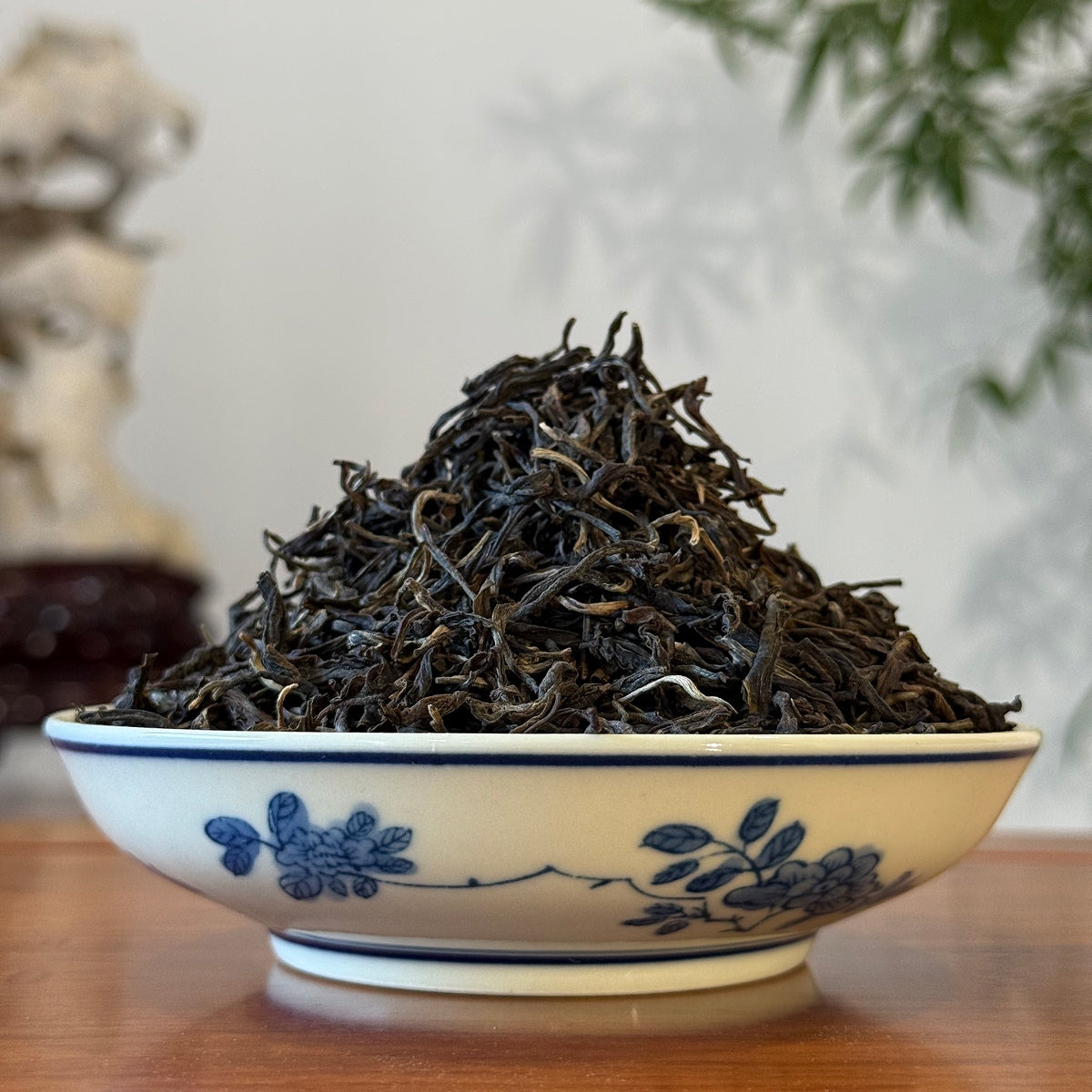 Loose Leaf Raw Pu-erh Tea 2022 Bing Dao sample dry leaves displayed in a tea house